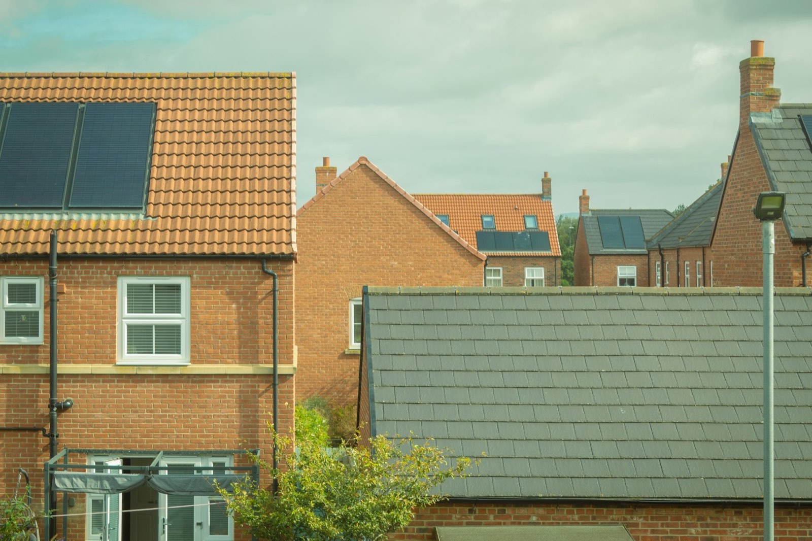 Solar panels on the tiled roofs of brick houses